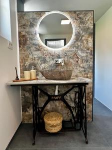 a bathroom with a sink and a mirror at Hiša Srečo in Begunje na Gorenjskem +81 photos