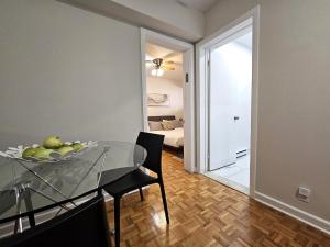 a dining room with a glass table and a bedroom at Where Comfort Meets Cozy Vibes in Montreal