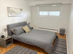 a bedroom with a bed and a window at Where Comfort Meets Cozy Vibes in Montreal