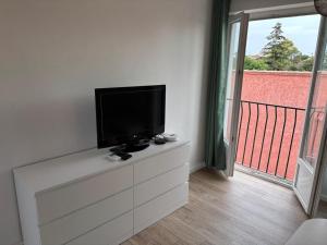 a flat screen tv sitting on top of a dresser at Studio 7 in Fos-sur-Mer