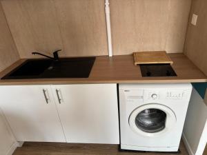 a small kitchen with a washing machine and a sink at Studio 7 in Fos-sur-Mer +8 photos