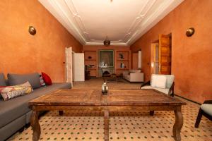 a living room with a table and a couch at Villa Dar Luz in Marrakesh