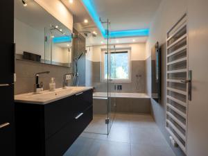 a bathroom with a sink and a shower and a tub at RABENSTEINER - Panorama Apartments - Bad Kleinkirchheim in Bad Kleinkirchheim