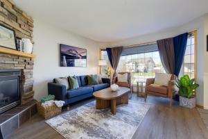 a living room with a blue couch and a fireplace at Lake Life Landing in Sylvan Lake