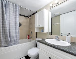 a bathroom with a sink and a toilet and a mirror at Lake Life Landing in Sylvan Lake +72 photos