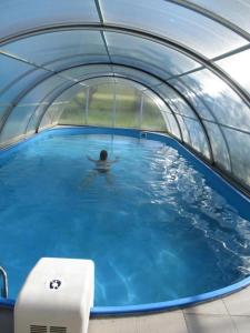 a person in a pool of water in a tunnel at Haus Franz in Zandt