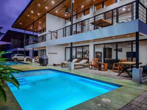 an exterior view of a house with a swimming pool at Samara by the River Vacation Suites in Sámara