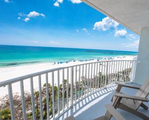 a balcony with a view of the beach and ocean at Palm & Tide Beachfront Hotel in Panama City Beach