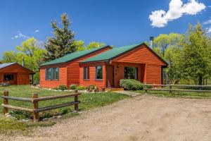 a cabin with a fence in front of it at Chickadee in Clark