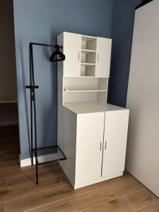a white closet with white cabinets and a black pole at Casa Agata in Chioggia