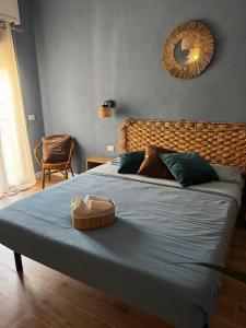 a bedroom with a large bed with a blue blanket at Casa Agata in Chioggia