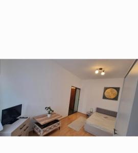 a living room with a couch and a tv at Enjoy Eden in Constanţa