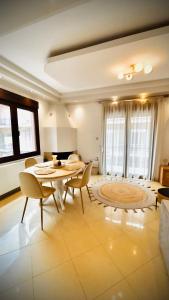 a large living room with a table and chairs at Fay's Apartment in Limenas +8 photos