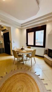 a large living room with a table and chairs at Fay's Apartment in Limenas
