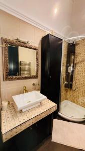 a bathroom with a white sink and a mirror at Fay's Apartment in Limenas