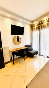 a living room with a table and a chair at Fay's Apartment in Limenas