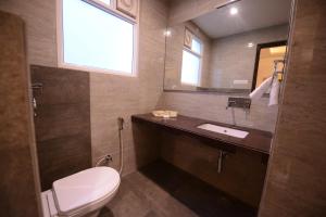 a bathroom with a toilet and a sink and a mirror at Silver Pride Boutique Hotel in Jaipur +13 photos