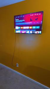 a flat screen tv hanging on a wall at North in Camby