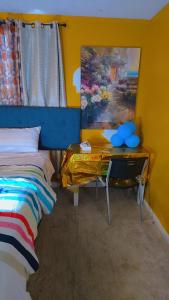 a bedroom with a desk next to a bed and a painting at North in Camby
