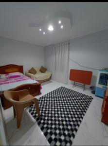 a bedroom with two beds and a black and white rug at شقة سوبر لوكس ثلاث غرف بعين شمس الشرقية in Cairo