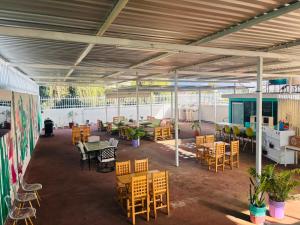 a patio with tables and chairs in a building at Hostel Casa Maguey in Oaxaca City