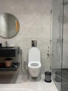 a bathroom with a toilet and a shower with a mirror at Spinoza House Agadir City Apartment in Agadir +20 photos