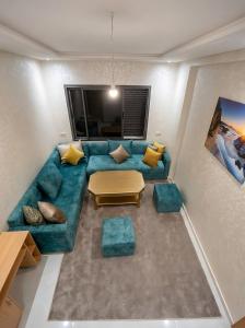 an overhead view of a living room with a blue couch at Spinoza House Agadir City Apartment in Agadir