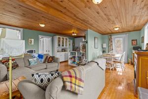 a living room with a couch and a table at Brigus Cottage Parking, Fire Pit & Garden in Brigus