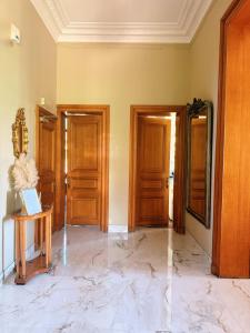 a room with two wooden doors and a marble floor at Manoir Borzeux in Stavelot