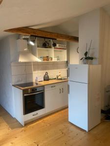 a kitchen with white appliances and a white refrigerator at Cesis city apartment in Cēsis