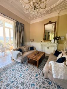 a living room with a couch and a table at Manoir Borzeux in Stavelot +40 photos