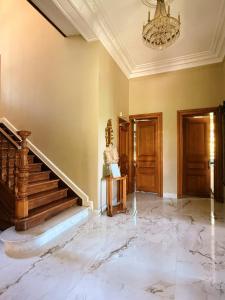 a large room with a staircase and a chandelier at Manoir Borzeux in Stavelot