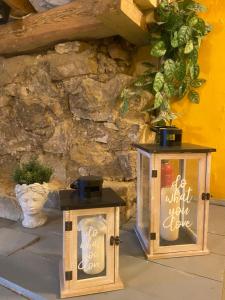 a couple of lanterns sitting next to a stone wall at Cesis city apartment in Cēsis