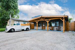 a white truck parked in front of a house at Rustic Old West Cabin 1 Block to Beach Accessible Private Yard in Sylvan Lake