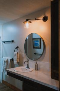 a bathroom with a sink and a mirror at Rustic Old West Cabin 1 Block to Beach Accessible Private Yard in Sylvan Lake +66 photos