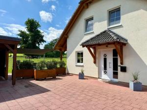 a house with a brick patio in front of it at Haus Muhblick in Schmallenberg