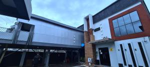 a building with a garage and a person standing outside at Kiarra Suites Owerri in Owerri