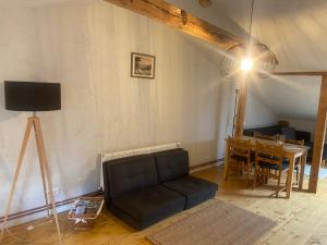 a living room with a couch and a table at Cesis city apartment in Cēsis +13 photos