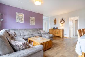 a living room with a couch and a table at Bungalow Windstille in Norddeich