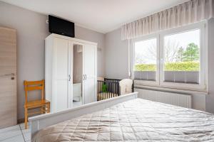 a bedroom with a bed and a tv on the wall at Bungalow Windstille in Norddeich