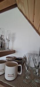 a table with cups and glasses on a table at Nest for Rest Nova Varos in Nova Varoš