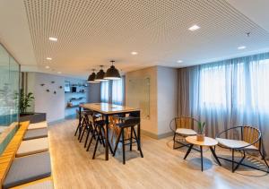a dining room with a table and chairs at Radisson Oscar Freire in São Paulo
