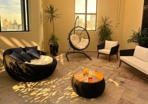 a living room with two chairs and a table at Radisson Oscar Freire in São Paulo