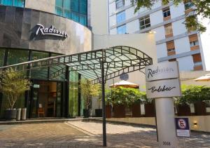 a street sign in front of a building at Radisson Oscar Freire in São Paulo