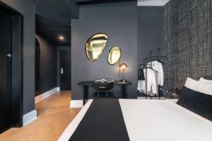 a bedroom with a bed and a table and a mirror at Madison Square Hotel Near NoMad in New York