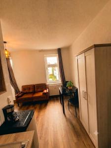a living room with a couch and a table at Modernes Apartment mit Küche in Groitzsch in Groitzsch