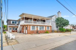 a brick house with a balcony on a street at Between Tides 3BR Walk to Beach Unit D in Seaside Park