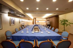 a conference room with a long table and chairs at Hotel Falcone in Lignano Sabbiadoro +76 photos