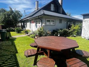 a wooden picnic table in front of a house at 1 room apartment with its own yard in Pärnu