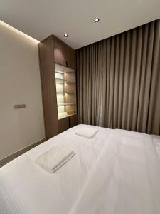 a bedroom with a bed with two towels on it at The Pearl Inn in Nizwa